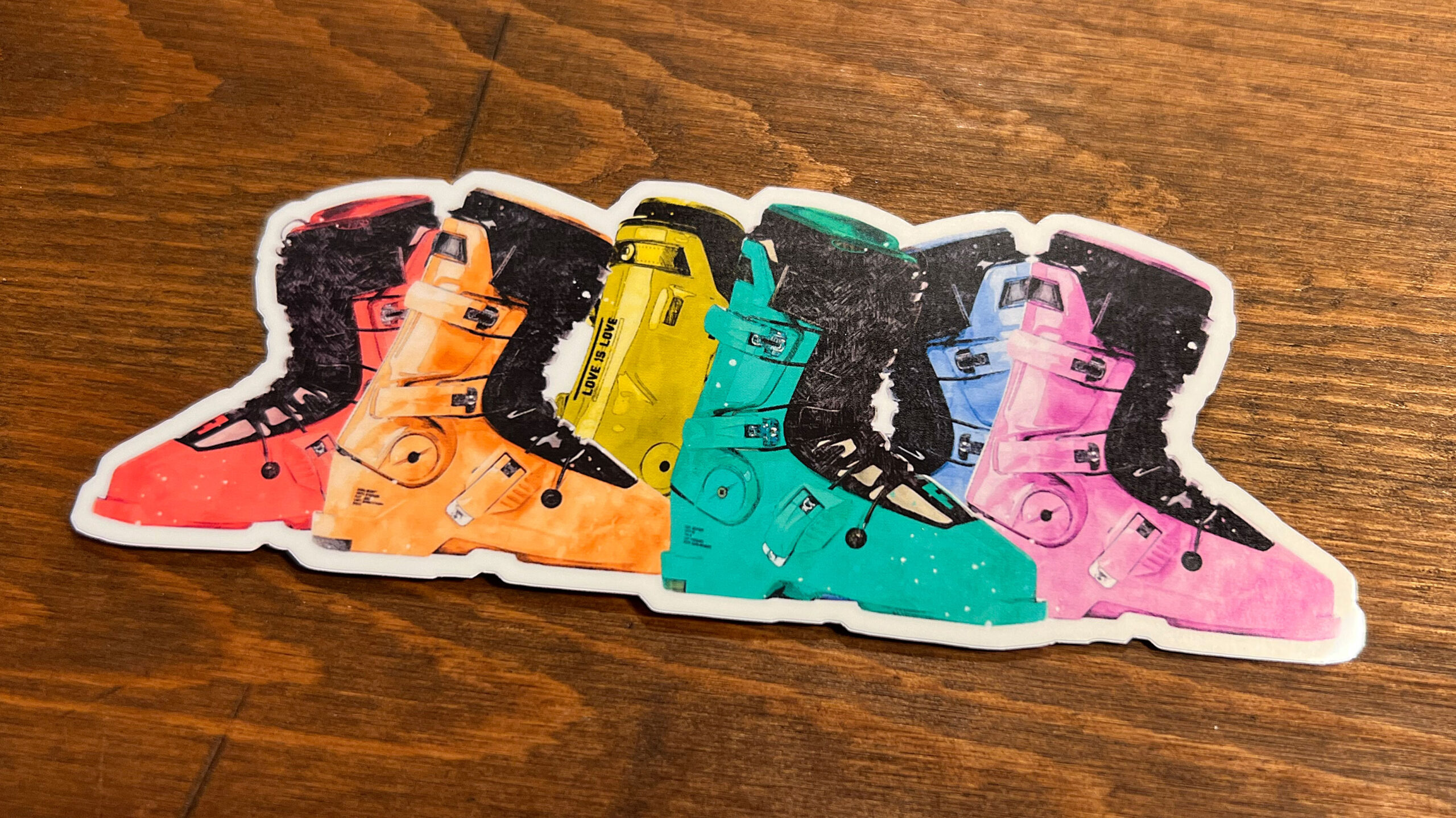 Vinyl Sticker featuring ski boots in pride rainbow colors